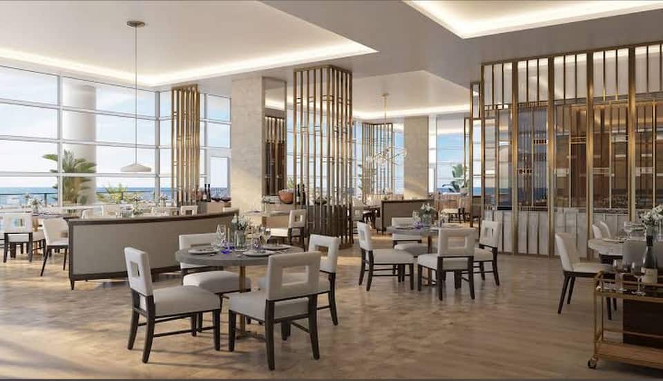 A bright resort lounge and dining area beside the windows