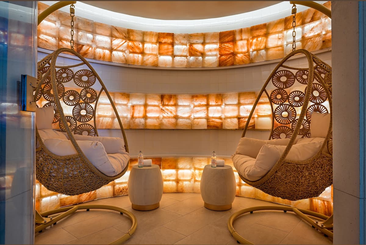 The salt inhalation lounge, glowing with backlit salt brick