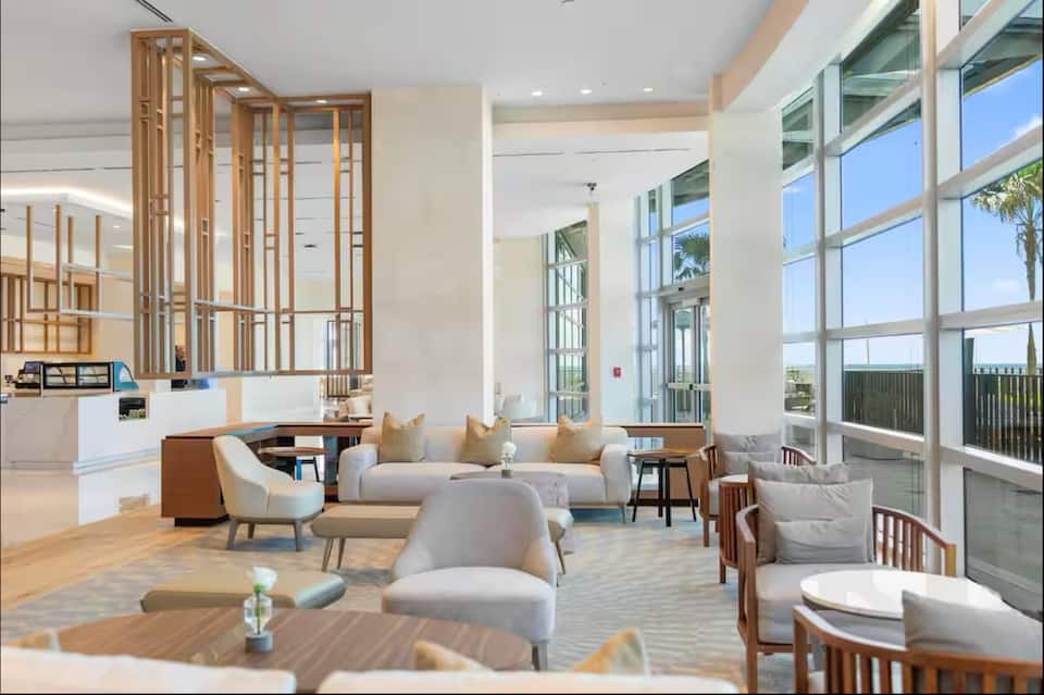 A lounge with soft seating and ocean views