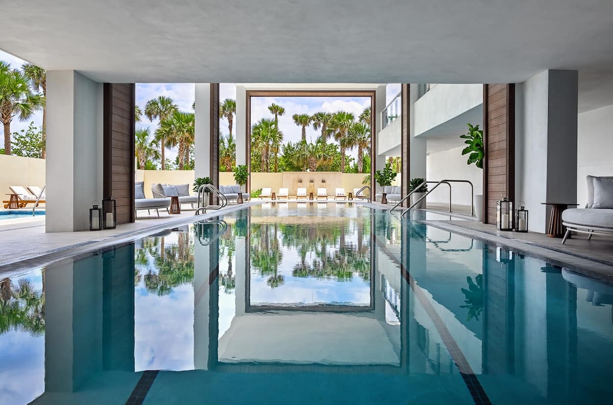 The indoor hydrotherapy lap pool with palm reflections in the glass