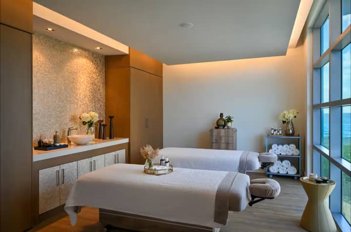 A spa treatment room prepared with a massage table