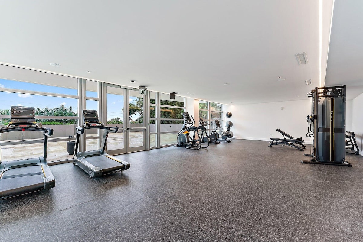 The resort fitness centre with treadmills and weights beside the windows