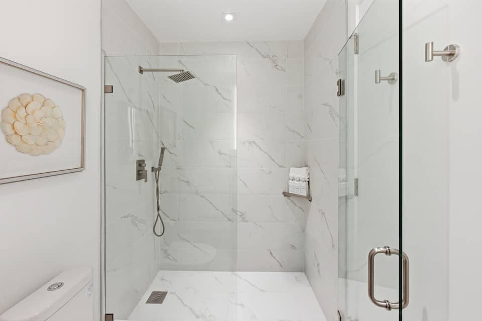 The marble walk-in rain shower in the second bathroom