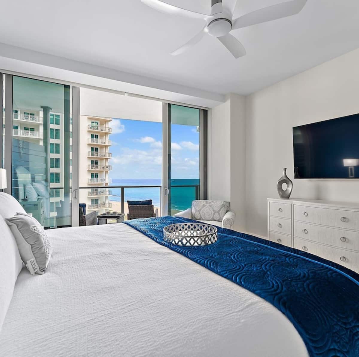 The king suite with the balcony and ocean beyond the glass