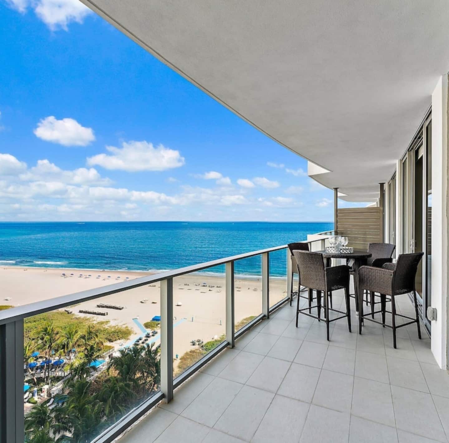 The curved balcony running the width of the residence, the beach twelve floors below