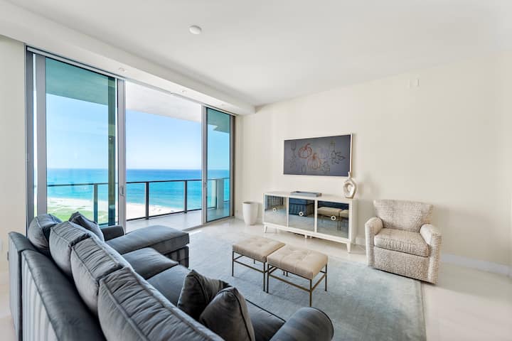 The living room with a deep sofa facing the ocean windows